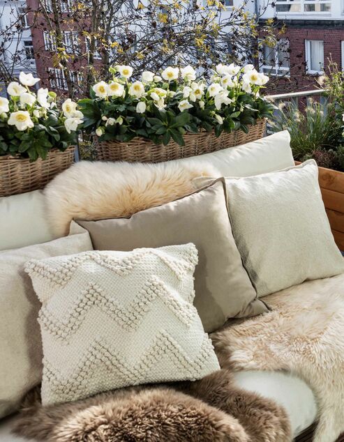 Comfortable seating on the balcony with a boho look.